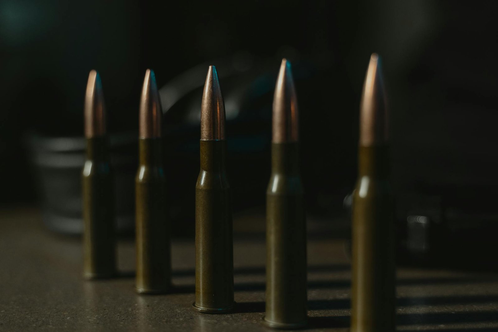 Detailed close-up image of bullet cartridges aligned in a row, showcasing ammunition design.